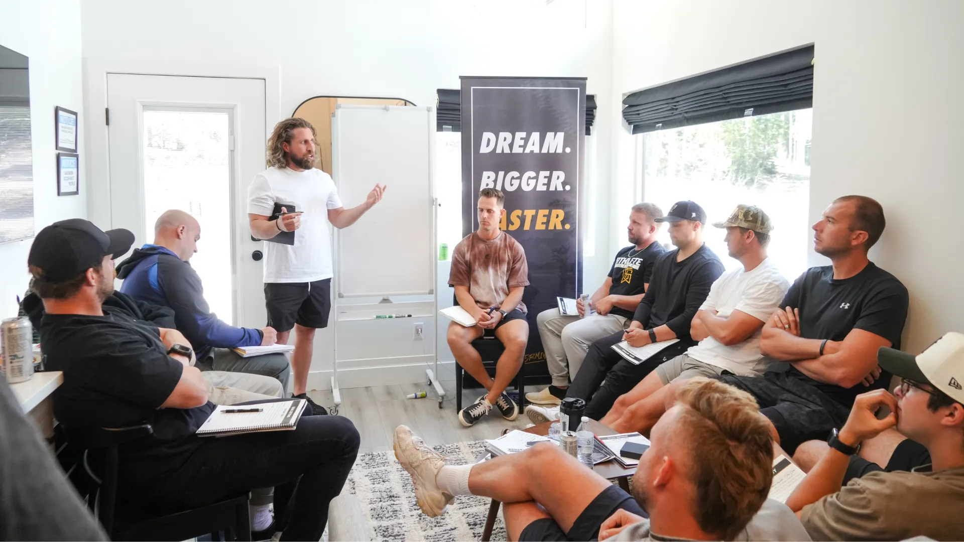 Brody mapping the plan on a whiteboard in front of DBF members