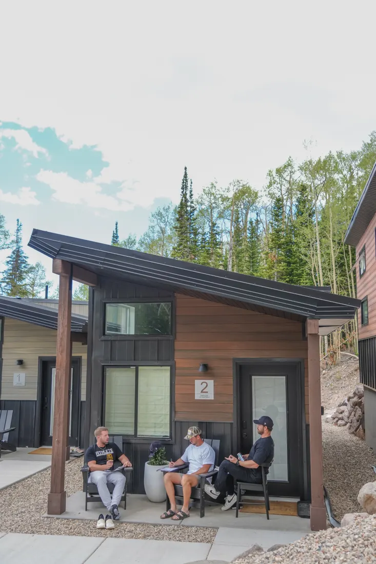 Members outside a cabin at a DBF mountain event