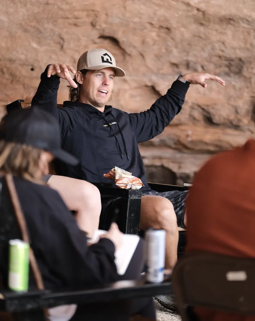 Brody speaking with members outdoors in the red rock